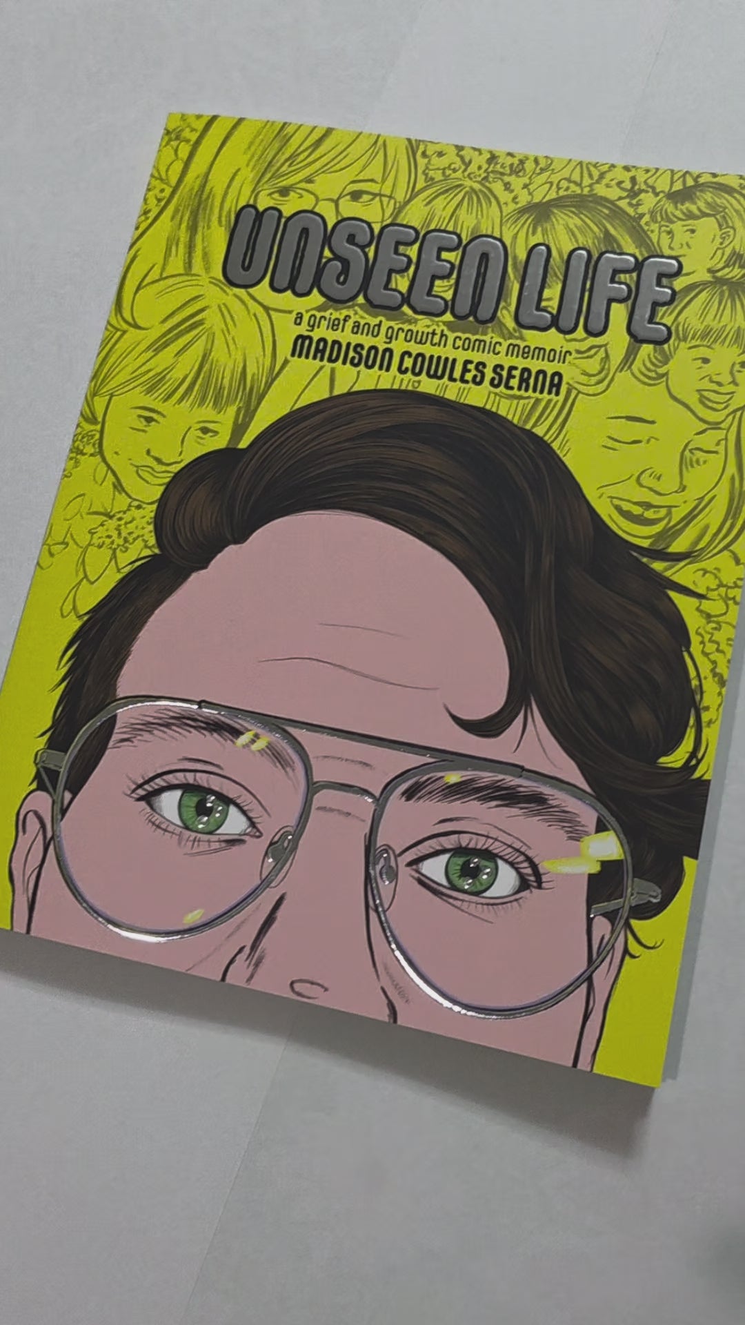 Preview of the shiny silver foil cover details on the book. The title, glasses, and highlights in the eyes are shiny.